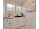 Bar area featuring a farmhouse sink, white cabinets, and a decorative piece at 736 Cedar St, Rock Hill, SC 29730