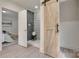 Bathroom with barn door, patterned tile shower, and gray tile flooring at 736 Cedar St, Rock Hill, SC 29730
