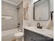 Modern bathroom with gray tile shower, white vanity, and black fixtures at 736 Cedar St, Rock Hill, SC 29730