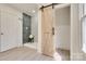 Bathroom with barn door, patterned tile shower, and gray tile flooring at 736 Cedar St, Rock Hill, SC 29730