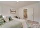 Bright bedroom with light green bedding and wood-look floors at 736 Cedar St, Rock Hill, SC 29730
