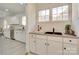 Built-in bar area with a farmhouse sink and white cabinets at 736 Cedar St, Rock Hill, SC 29730