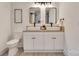 Bathroom with double vanity, modern lighting, and patterned tile shower at 736 Cedar St, Rock Hill, SC 29730