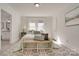 Light and airy bedroom with a light green bedspread and patterned rug at 736 Cedar St, Rock Hill, SC 29730