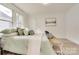 Bedroom with light green bedding, wood-look floors, and window light at 736 Cedar St, Rock Hill, SC 29730