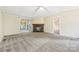 Living room with carpet, stone fireplace, and sliding glass doors at 1472 Fritts Ave, Fort Mill, SC 29715