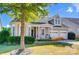 Craftsman style home with gray siding, a metal roof, and rocking chairs on the porch at 5021 Henshaw Rd, Waxhaw, NC 28173