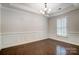 Bright dining room with hardwood floors, white wainscoting, and plantation shutters at 5021 Henshaw Rd, Waxhaw, NC 28173