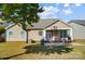 Tan house exterior with covered patio and lawn at 5021 Henshaw Rd, Waxhaw, NC 28173
