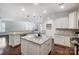 Island kitchen with granite countertops and white cabinets at 5021 Henshaw Rd, Waxhaw, NC 28173