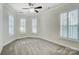 Spacious bedroom with neutral carpeting, plantation shutters, and ceiling fan at 5021 Henshaw Rd, Waxhaw, NC 28173
