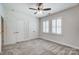 Well-lit bedroom with double doors and carpet at 5021 Henshaw Rd, Waxhaw, NC 28173