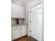 Convenient laundry room with cabinets and access to additional storage at 5021 Henshaw Rd, Waxhaw, NC 28173