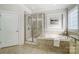 Elegant bathroom with soaking tub, shower, and granite vanity at 5021 Henshaw Rd, Waxhaw, NC 28173