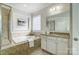 Spa-like bathroom featuring a soaking tub and walk-in shower at 5021 Henshaw Rd, Waxhaw, NC 28173
