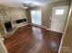 Living room with hardwood floors, stone fireplace and built-in shelving at 614 Kenlough Dr, Charlotte, NC 28209