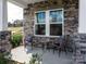 Inviting front porch with stone facade and wicker chairs at 109 Sentinel Ct, Mooresville, NC 28115