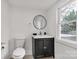 Modern and sleek bathroom with black vanity, round mirror, and updated fixtures at 139 Ebenezer Ave, Rock Hill, SC 29730