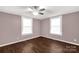 Bedroom with mauve walls, wood-look flooring, a ceiling fan, and two windows at 139 Ebenezer Ave, Rock Hill, SC 29730