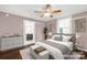 A cozy bedroom with ceiling fan, ensuite bathroom, and large window providing natural light at 139 Ebenezer Ave, Rock Hill, SC 29730