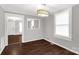 Dining room with wood-look flooring, a light fixture, a window, and a pass-through to another room at 139 Ebenezer Ave, Rock Hill, SC 29730