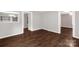 Empty room with dark wood-look flooring, white walls, and doorways to other areas of the house at 139 Ebenezer Ave, Rock Hill, SC 29730