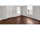 Empty room featuring dark wood-look flooring, a white front door, and window with blinds at 139 Ebenezer Ave, Rock Hill, SC 29730