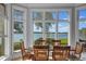 Dining room with lake views, hardwood floors, and a large bay window at 18212 Pompano Pl, Cornelius, NC 28031