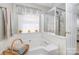 Relaxing bathroom with corner tub, shower, and window at 6859 Lakecrest Ct, Denver, NC 28037