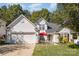 Two-story house with attached garage and landscaped yard at 6859 Lakecrest Ct, Denver, NC 28037