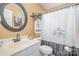 Clean bathroom with white vanity, oval mirror, and shower at 6859 Lakecrest Ct, Denver, NC 28037