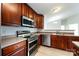 Kitchen with stainless steel appliances and dark wood cabinets at 17123 Doe Valley Ct, Cornelius, NC 28031