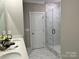 Bathroom with marble shower, double vanity, and modern fixtures at 1040 Bull Dog Ln, Wingate, NC 28174