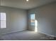 Bright bedroom with carpeted floors and large window at 1040 Bull Dog Ln, Wingate, NC 28174