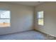 Bright bedroom with two windows and neutral colored carpeting at 1044 Bull Dog Ln # 38, Wingate, NC 28174