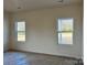 Spacious bedroom with two large windows and neutral walls at 1044 Bull Dog Ln, Wingate, NC 28174