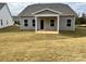 Newly sodded backyard with a covered patio, providing a tranquil outdoor space at 1044 Bull Dog Ln, Wingate, NC 28174