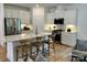 Modern kitchen with white cabinets, quartz countertops, and a large island with seating at 1044 Bull Dog Ln, Wingate, NC 28174