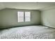 Large bonus room with two windows and neutral wall color at 1053 Bull Dog Ln, Wingate, NC 28174