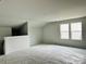 Spacious bonus room featuring a half wall and two windows at 1053 Bull Dog Ln, Wingate, NC 28174