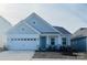 Newly built home featuring gray siding, white trim, and a two-car garage at 1053 Bull Dog Ln, Wingate, NC 28174