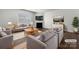 Virtually staged living room featuring gray sofas, a fireplace, and dark hardwood floors at 9305 Ketchum Dr, Gastonia, NC 28056