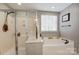 Main bathroom with soaking tub, walk-in shower, and double vanity at 1002 Matilda Ln, Indian Trail, NC 28079