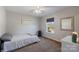 Bright bedroom with window, carpet, and a ceiling fan at 309 Commodore Loop, Mooresville, NC 28117