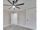 Spacious bedroom with ceiling fan, neutral walls, and two closets at 13915 Pheasantwood Ln, Matthews, NC 28105