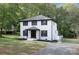 Two-story house with white brick, black trim, and a well-manicured lawn at 8946 Glencroft Rd, Mint Hill, NC 28227