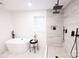 Modern bathroom with soaking tub, double shower heads, and floating vanity at 8946 Glencroft Rd, Mint Hill, NC 28227