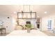 Modern dining area with white table and chairs, open to the kitchen at 8946 Glencroft Rd, Mint Hill, NC 28227