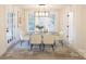 Elegant dining room with a glass-top table and six white chairs at 8946 Glencroft Rd, Mint Hill, NC 28227