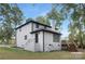 White brick house with deck, landscaping, and mature trees at 8946 Glencroft Rd, Mint Hill, NC 28227